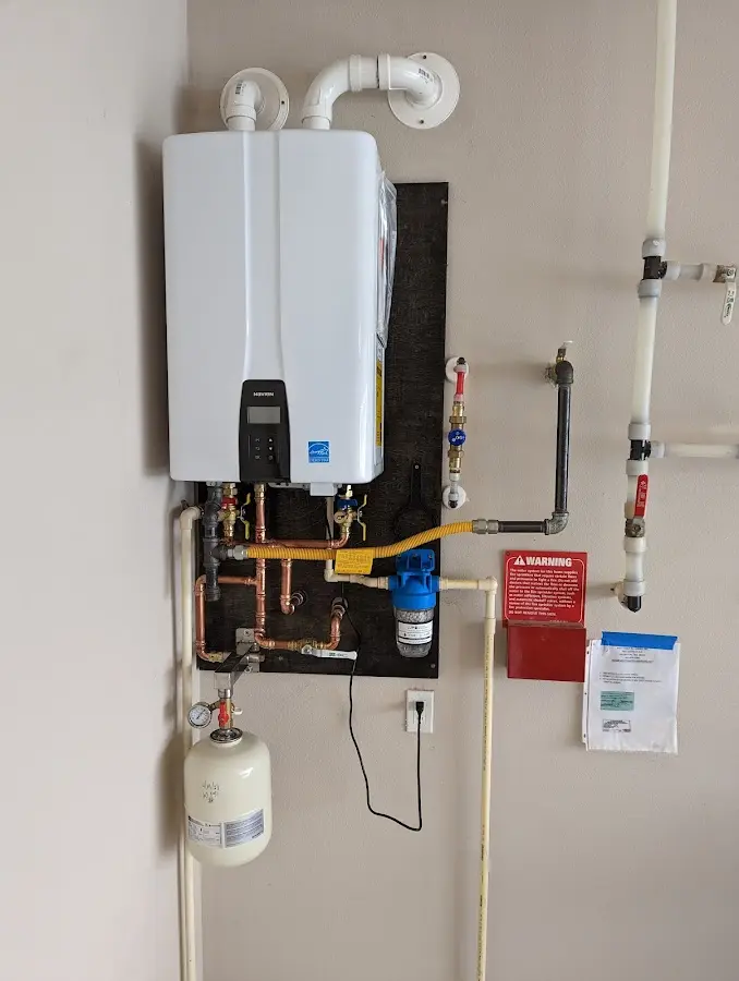 Professional plumber installing copper piping in a Nixa home
